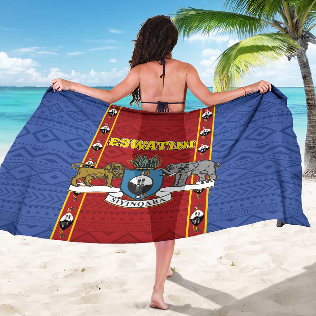 African shield print sarong with blue geometric pattern and red center panel, fully draped