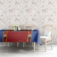 Blue tablecloth with red center panel and shield-style emblem motifs