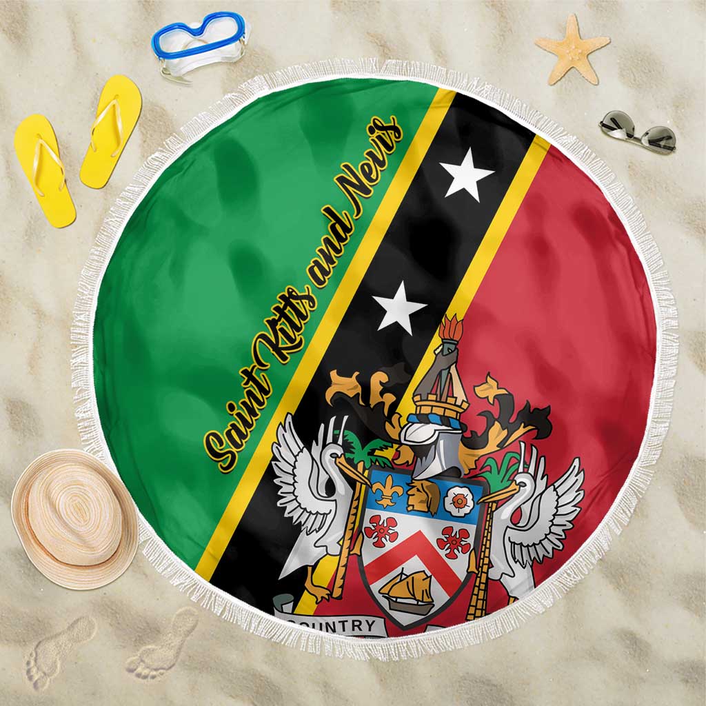 Round beach blanket laid flat: green black and red Saint Kitts and Nevis crest with white fringed edge
