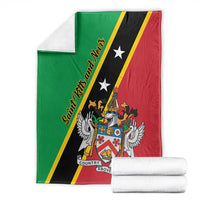 Green, black, and red Saint Kitts and Nevis blanket folded, with crest, wings, and star details
