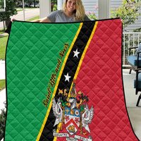 Green and red quilt blanket held up, featuring black stripe with stars and crest