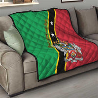 Green and red quilt throw on a sofa with black diagonal stripe and star crest