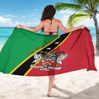 Green and red flag-print sarong with diagonal black and yellow bands, draped