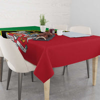 Red tablecloth with green-and-black side panel, draped over dining table with corner drop