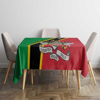 Red and green tablecloth with black stripe and “Country Above Self” design on table