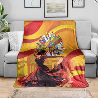 Yellow and red flamenco portrait throw blanket with text-style design and circular emblem.