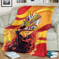Yellow, red, and black flamenco throw blanket draped over a sofa with central emblem.
