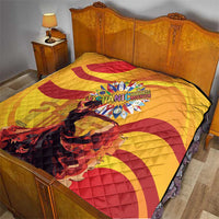 Yellow quilt with red spiral swirls and a central Hispanic Heritage festival graphic