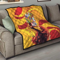 Yellow quilt with red circular swirl design and central round emblem on sofa