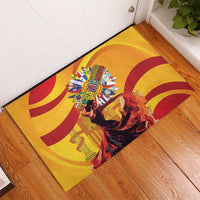 Yellow rubber doormat with flamenco dancers and colorful emblem at center
