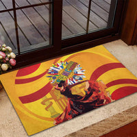 Yellow rubber doormat with red swirl patterns and central Hispanic Heritage emblem