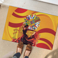 Yellow rubber doormat with flamenco dancer print, red stripes, and colorful burst emblem