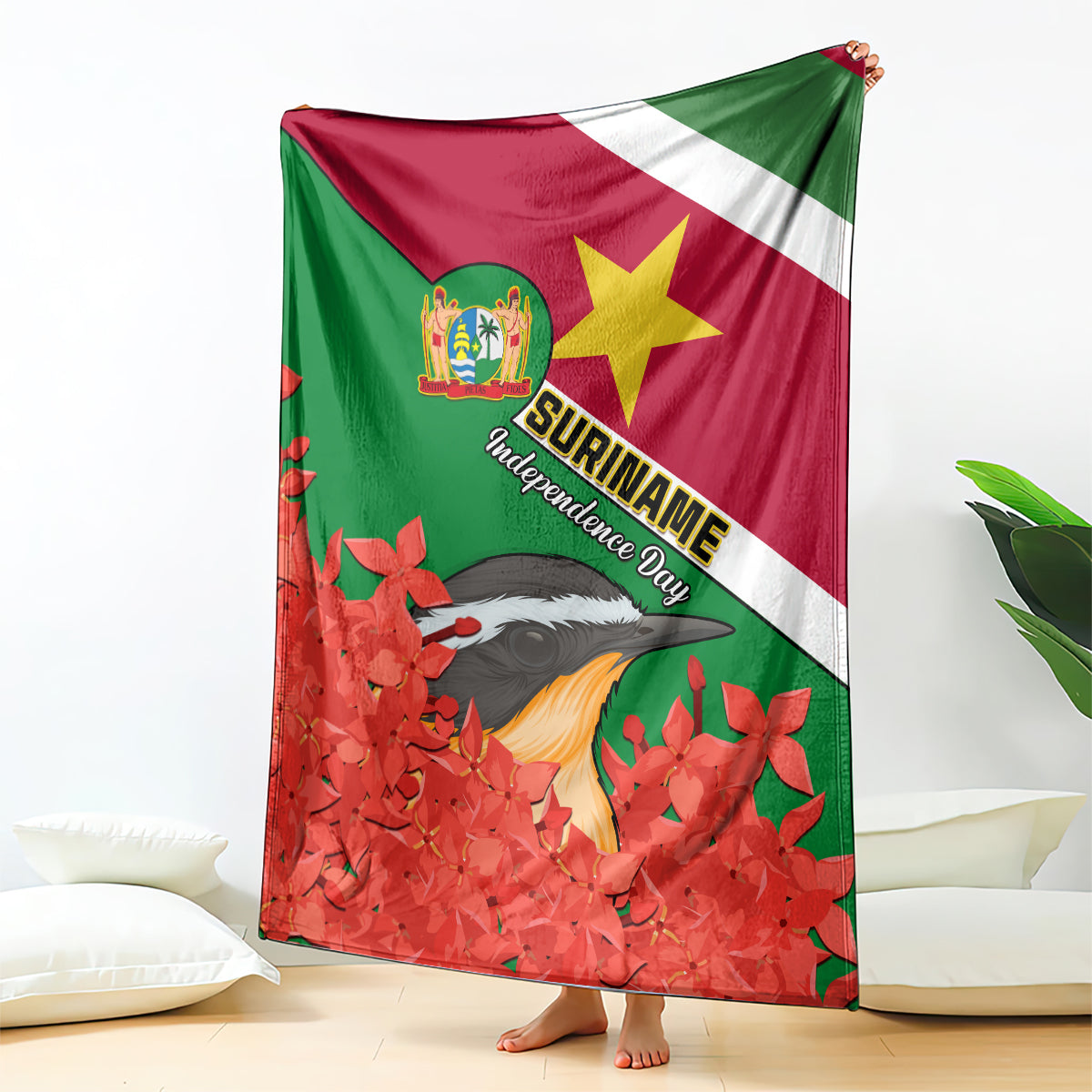 Suriname flag blanket with bird and red jungle flame flowers, draped on floor