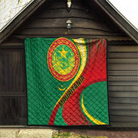 Mauritania quilt blanket displayed inside a dark wooden shelter, green red yellow flag