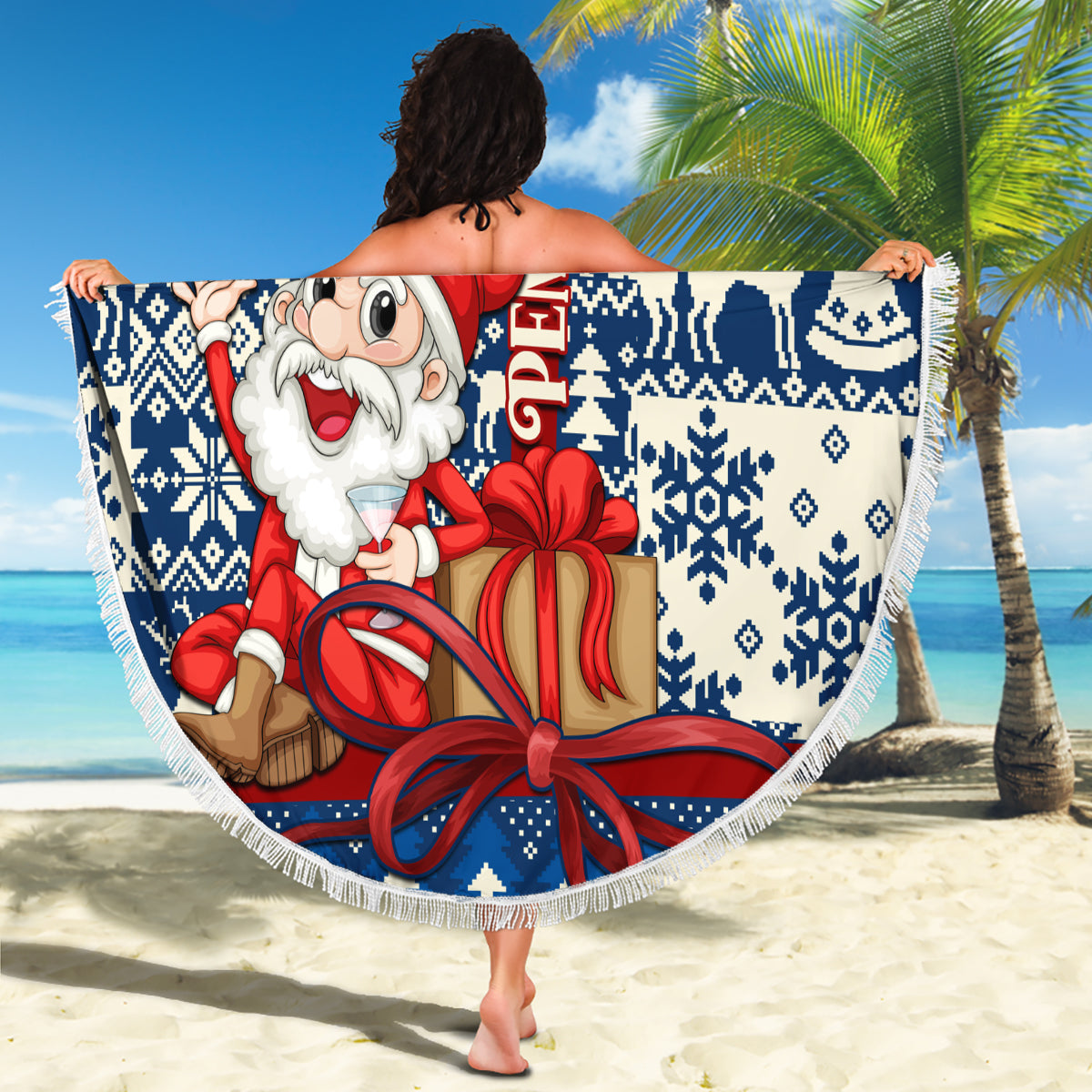 Round blue and white Santa holding gift beach blanket with fringe edge, festive pattern.