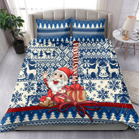Blue Christmas bedding set with Santa carrying a gift, snowflake and tree motifs