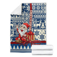 Folded blue Santa Christmas blanket with gift bow, fair isle snowflake and reindeer pattern