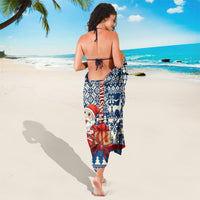 Blue Christmas sarong with Santa face and red bow print, tied at back