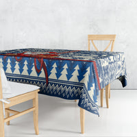 Blue Christmas tablecloth with pine tree and geometric snowflake pattern, draped