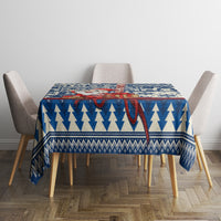 Blue Christmas tablecloth with pine tree rows, snowflake border and red accent