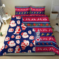 Blue Christmas bedding set with Santa faces, presents, reindeer, and multicolor holiday stripes
