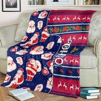 Christmas throw blanket showing Santa figures, reindeer, ornaments, and zigzag border pattern