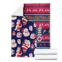 Folded Christmas blanket set with Santa, reindeer, gifts, and zigzag stripe design on dark blue