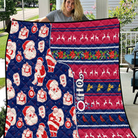 Blue Christmas quilt blanket with Santa, gifts, and reindeer on red and navy stripes