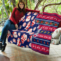 Blue Christmas quilt spread on outdoor seat with Santa, gifts, and red navy stripes