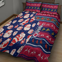 Blue and red Christmas quilt bed set with Santa and gift print, shown with two pillow shams