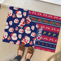 Blue Christmas rubber doormat by shoes, Santa and gift graphics with patterned border