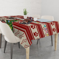 Red Christmas tablecloth with dog bone icons, paw prints, and pug dog centerpiece
