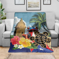 Blue blanket on sofa with El Morro tower, coqui frog, palm leaves, hibiscus flowers and star