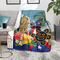 Blue blanket folded on chair with El Morro tower, coqui frog, palm leaves, flowers and star