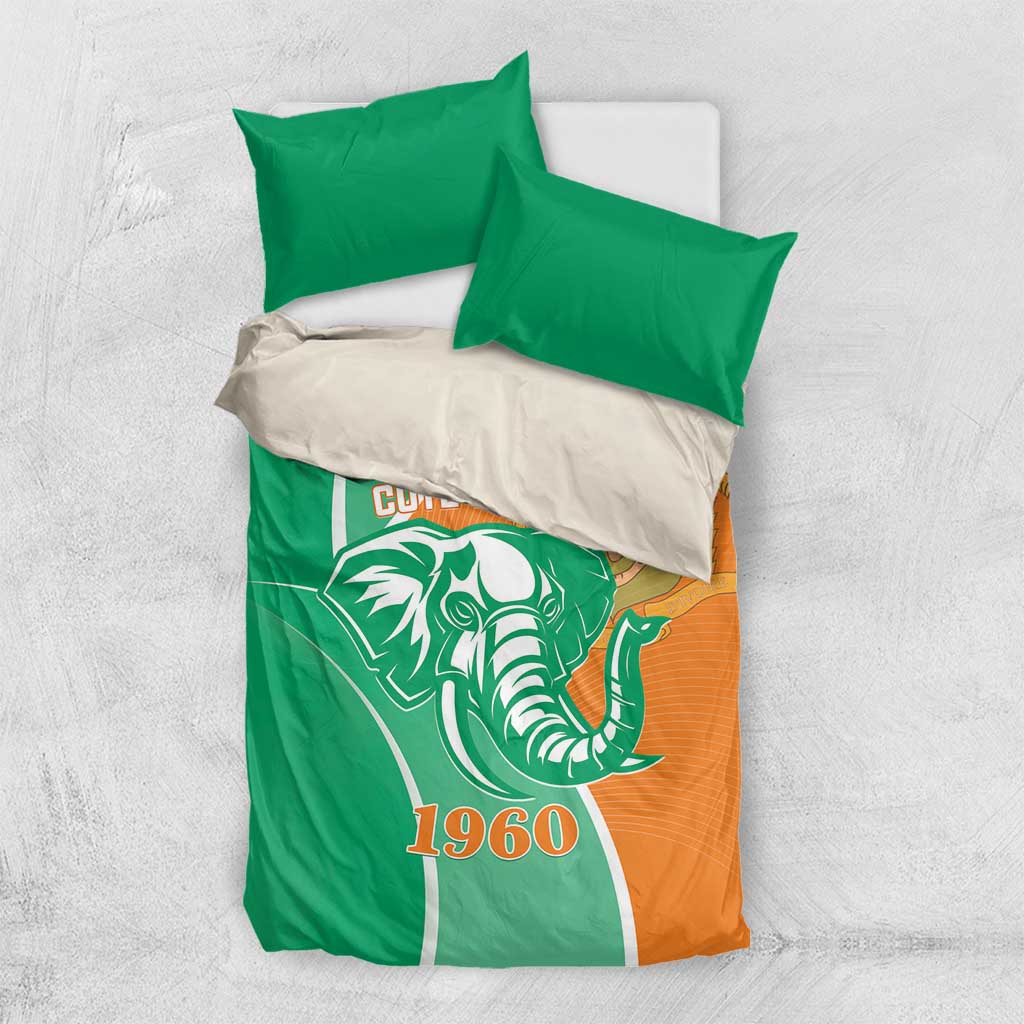 Green and orange Cote d'Ivoire elephant bedding set laid flat with two pillowcases