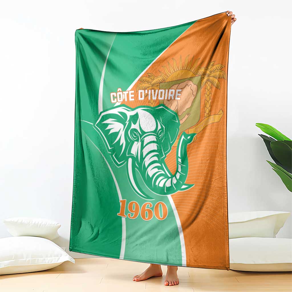 Cote d'Ivoire independence day blanket, draped view, elephant and 1960 design, green and orange