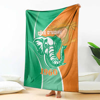 Cote d'Ivoire independence day blanket, draped view, elephant and 1960 design, green and orange
