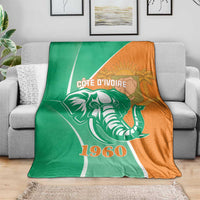 Cote d'Ivoire independence day blanket on sofa, elephant and 1960 graphic in green and orange