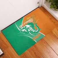 Orange and green rubber doormat with Cote d'Ivoire elephant emblem and 1960 text