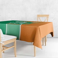 Two-tone green and orange tablecloth draped over a dining table, corner hanging