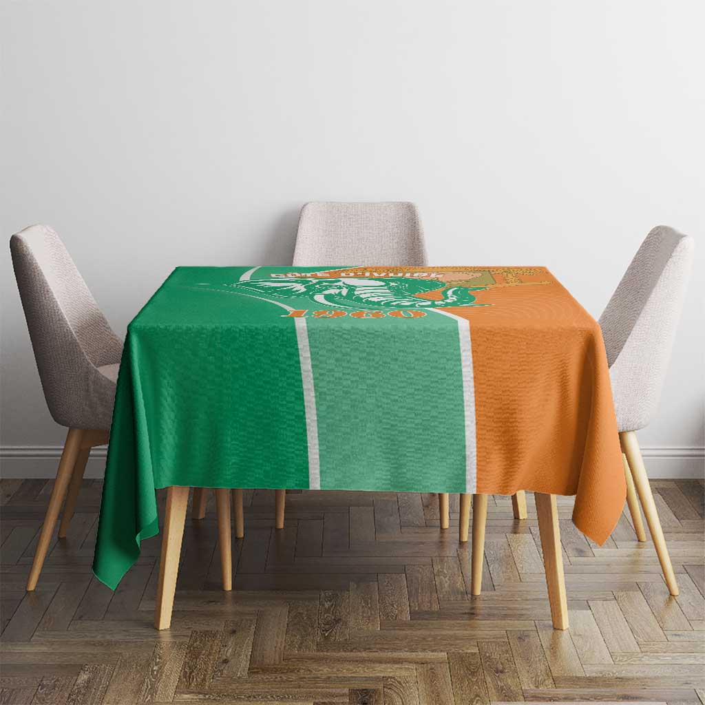 Two-tone green and orange elephant design tablecloth on dining table with chairs