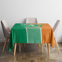 Two-tone green and orange elephant design tablecloth on dining table with chairs