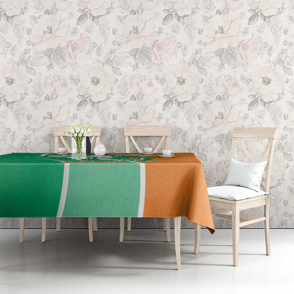 Two-tone green and orange elephant-themed tablecloth on long dining table
