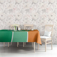 Two-tone green and orange elephant-themed tablecloth on long dining table