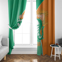 Window curtain pair with green and orange panels, elephant emblem over vertical seam