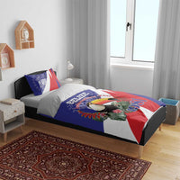 Blue bedding set with toucan and 1981 print, on bed with matching pillow shams.