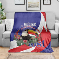 Belize Independence Day 1981 blanket on sofa, blue/red/white flag with toucan and 1981