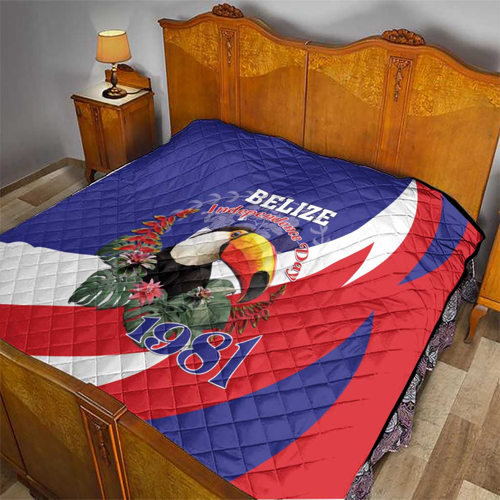 Blue red and white Belize Independence 1981 quilt on bed, with toucan and floral design.
