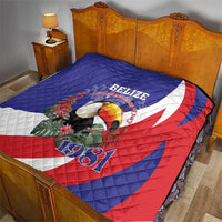 Blue red and white Belize Independence 1981 quilt on bed, with toucan and floral design.