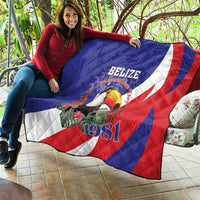 Blue and red Belize Independence 1981 quilt with toucan artwork and diagonal stripe panels.
